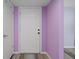 White front door and lavender walls in an entryway at 3849 Staysail Ln, Holiday, FL 34691
