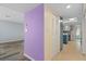 Hallway view of a home with lavender and yellow walls at 3849 Staysail Ln, Holiday, FL 34691