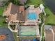 Drone view of community pool and shuffleboard courts at 3849 Staysail Ln, Holiday, FL 34691