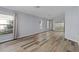 Spacious living room with wood-look floors and plenty of natural light at 3849 Staysail Ln, Holiday, FL 34691