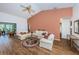 Living room with neutral decor and view into adjacent room at 9727 Oakwood Hills Ct, New Port Richey, FL 34655