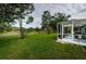 Large backyard with lush grass and golf course views at 9727 Oakwood Hills Ct, New Port Richey, FL 34655