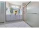 Clean bathroom with double vanity and a walk-in shower at 9727 Oakwood Hills Ct, New Port Richey, FL 34655