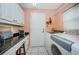 Bright laundry room with washer, dryer, and built-in workspace at 9727 Oakwood Hills Ct, New Port Richey, FL 34655