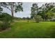 Expansive grassy backyard offering serene golf course views at 9727 Oakwood Hills Ct, New Port Richey, FL 34655
