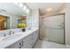 Bathroom with double vanity and a walk-in shower at 9727 Oakwood Hills Ct, New Port Richey, FL 34655