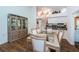 Dining area with glass-top table and built-in hutch, open to kitchen at 9727 Oakwood Hills Ct, New Port Richey, FL 34655