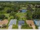 Aerial view of a community with houses, golf course, and pond at 9727 Oakwood Hills Ct, New Port Richey, FL 34655