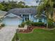 Light blue house with landscaping and driveway at 9727 Oakwood Hills Ct, New Port Richey, FL 34655