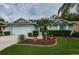 Single-Gathering home with light blue exterior and landscaping at 9727 Oakwood Hills Ct, New Port Richey, FL 34655