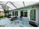 Screened patio with table and chairs, ideal for outdoor dining at 9727 Oakwood Hills Ct, New Port Richey, FL 34655