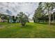 Landscaped backyard showcasing the home's exterior at 9727 Oakwood Hills Ct, New Port Richey, FL 34655