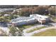 Aerial view of community clubhouse with manicured lawns, mature trees, and ample parking at 11836 Carissa Ln # B, New Port Richey, FL 34654