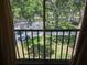 Balcony view of lush greenery, water, and a street, providing a vibrant, picturesque outlook at 5265 E Bay Dr # 420, Clearwater, FL 33764