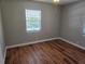 Bedroom featuring wood flooring, neutral paint, and a large window for natural light at 5265 E Bay Dr # 420, Clearwater, FL 33764