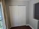Bedroom closet featuring double doors, neutral paint, and base molding at 5265 E Bay Dr # 420, Clearwater, FL 33764
