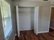 Bedroom closet with bifold doors, shelving, and hardwood floor, offering ample storage at 5265 E Bay Dr # 420, Clearwater, FL 33764
