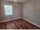 Bedroom features wood-look flooring and a window providing natural light, enhancing the modern feel at 5265 E Bay Dr # 420, Clearwater, FL 33764