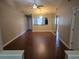 Open dining room with hardwood floors, chandelier, and pass through to the kitchen at 5265 E Bay Dr # 420, Clearwater, FL 33764