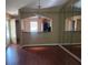 Open dining room featuring hardwood floors, modern chandelier, and view into the kitchen at 5265 E Bay Dr # 420, Clearwater, FL 33764