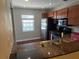 Efficient kitchen featuring stainless steel appliances, granite countertops and wood cabinetry at 5265 E Bay Dr # 420, Clearwater, FL 33764