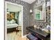 Stylish vanity area features a black desk and art deco wallpaper at 11836 Carissa Ln # B, New Port Richey, FL 34654