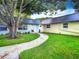 Landscaped front yard with a curved walkway to the entrance at 11836 Carissa Ln # B, New Port Richey, FL 34654