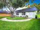 Condo with a curved walkway and large shade tree at 11836 Carissa Ln # B, New Port Richey, FL 34654