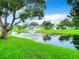 Serene pond view with fountain and lush landscaping at 11836 Carissa Ln # B, New Port Richey, FL 34654
