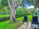 Enjoy this peaceful patio setting with two rocking chairs and pond view at 11836 Carissa Ln # B, New Port Richey, FL 34654
