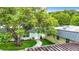 Home exterior and walkway seen from above, nestled amongst trees at 11836 Carissa Ln # B, New Port Richey, FL 34654