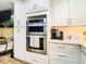Updated kitchen with stainless steel double oven and microwave at 11836 Carissa Ln # B, New Port Richey, FL 34654