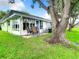 Charming single story home with patio, rocking chairs, and lush lawn at 11836 Carissa Ln # B, New Port Richey, FL 34654