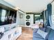 Open living space with large TV, comfortable seating, and laundry area at 11836 Carissa Ln # B, New Port Richey, FL 34654
