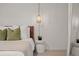 Serene bedroom with a bed, side table, and a wall-mounted light fixture at 1108 66Th Nw St, Bradenton, FL 34209