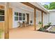 Inviting front porch with wooden posts and seating area at 1108 66Th Nw St, Bradenton, FL 34209