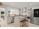 Modern kitchen with stainless steel appliances and light wood cabinets at 1108 66Th Nw St, Bradenton, FL 34209