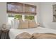Bedroom with a double bed, neutral tones, and natural light from large windows at 1108 66Th Nw St, Bradenton, FL 34209