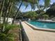 Community pool area with lush landscaping at 5265 E Bay Dr # 420, Clearwater, FL 33764