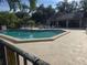 Community pool with lounge chairs and cabana at 5265 E Bay Dr # 420, Clearwater, FL 33764