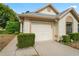 White house with gray roof, attached garage, and well-manicured landscaping at 9108 Bassett Ln # B, New Port Richey, FL 34655
