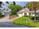Tan two-car garage villa with gray roof and landscaping at 9108 Bassett Ln # B, New Port Richey, FL 34655