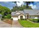 Front view of a house with a gray roof and green lawn at 9108 Bassett Ln # B, New Port Richey, FL 34655