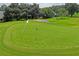 Golf course green with flag and surrounding landscape at 9108 Bassett Ln # B, New Port Richey, FL 34655
