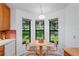 Bright kitchen with wood cabinets and a view from the breakfast nook at 9108 Bassett Ln # B, New Port Richey, FL 34655