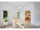 Bright dining room with kitchen view and light wood table at 9108 Bassett Ln # B, New Port Richey, FL 34655