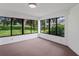 Sunroom with wall-to-wall windows and view of backyard at 9108 Bassett Ln # B, New Port Richey, FL 34655