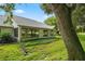 House exterior showcasing large windows and mature tree at 9108 Bassett Ln # B, New Port Richey, FL 34655