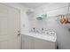 Convenient laundry room with washer, dryer, and shelving at 9108 Bassett Ln # B, New Port Richey, FL 34655