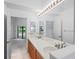 Double vanity bathroom with a shower and view of bedroom at 9108 Bassett Ln # B, New Port Richey, FL 34655